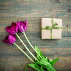 Tulip flowers and gift. Flat lay, Top view