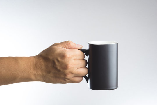 Hand hold dark cup of drink