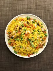 Frozen instant paella after cooked lie over textile sofa.