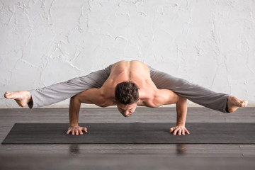 Fototapeta premium A man doing yoga exercises
