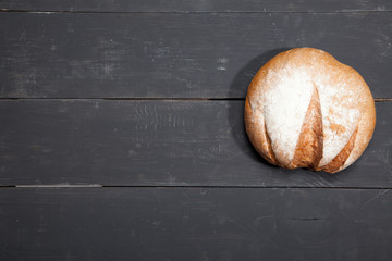 Homemade bread on a black wooden background