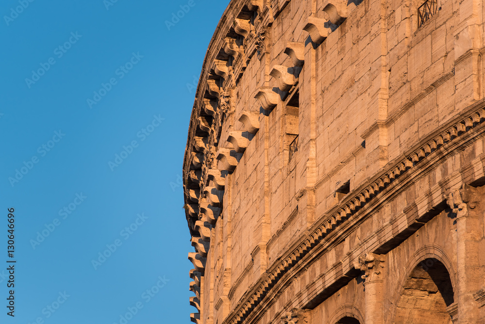 Wall mural Rome Colosseum detail lit by sunset