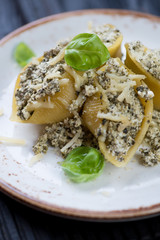Closeup of conchiglione with cottage cheese and spinach stuffing