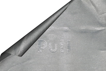 Closeup of aluminum cigarette foil paper with a curled corner.
