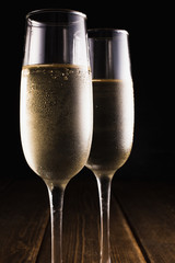Transparent wineglasses with champagne isolated on black background.