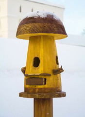 Wooden feeder for birds in the form of fungus