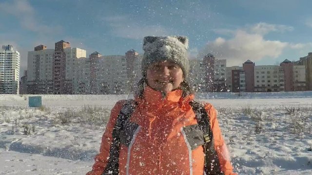 Woman Thowing up Snow and Smiling Enjoy Winter
