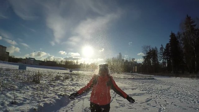 Woman Thowing up Snow and Smiling