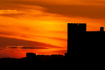 Silhouette of a castle over amazing red sky