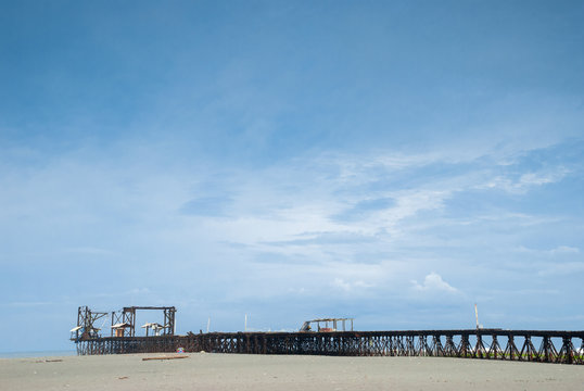 Old rusty pier in Guatemala shot in a cloudy morning. Champerico 