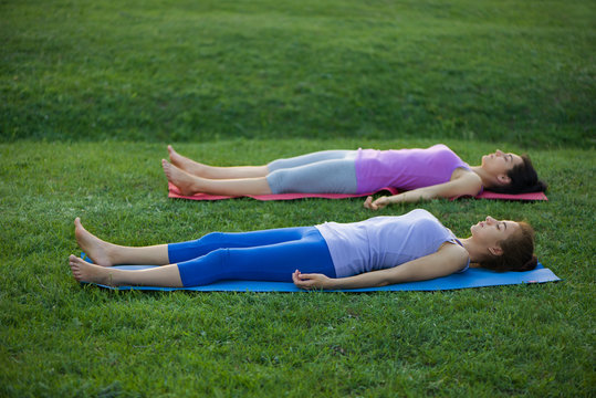 women doing yoga outdoors