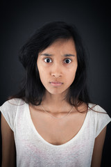 Beautiful woman doing different expressions in different sets of clothes: angry