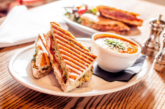 Club sandwich pressed panini with chicken, tomato, cheese and a side of tomato soup