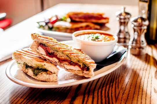 Club sandwich pressed panini with chicken, tomato, cheese and a side of tomato soup