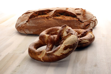 Different kinds of bread rolls on white board from above. Kitchen or bakery poster design.