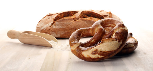 Different kinds of bread rolls on white board from above. Kitchen or bakery poster design.