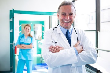 Portrait of doctor and nurse standing with arms crossed