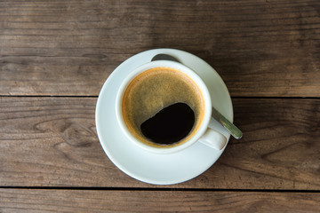 cup of fresh coffee with coffee beans on wooden table © somchaichoosiri