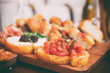 Italian appetizers on wooden plank