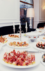 Meat and fish appetizers in a restaurant, toned