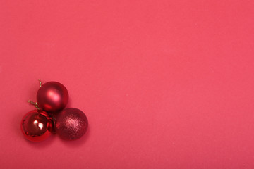 Red christmas balls on a red background