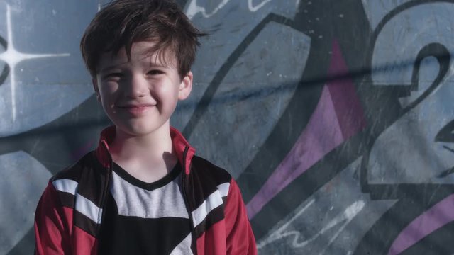4k Colourful Close-up of a Boy smiling on Graffiti Background
