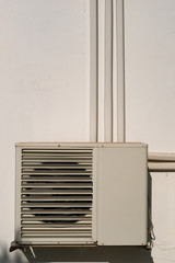 Condensing unit at the white wall
