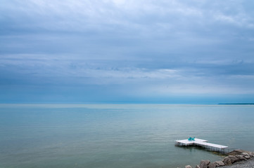 Adirondack or Muskoka Chairs on the dock overlooking the water at the cottage