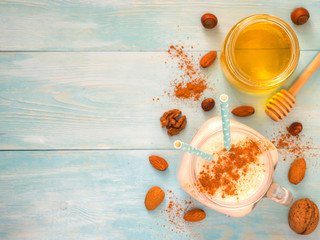 Banana smoothie on turquoise background with copyspace