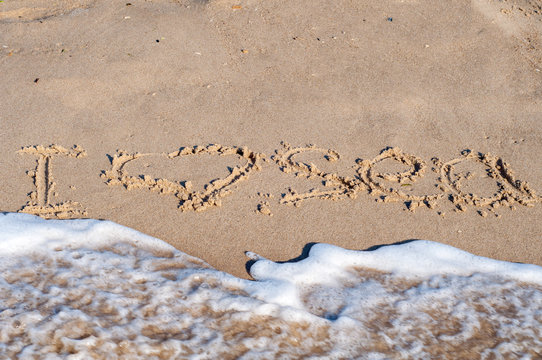 I love the sea. the inscription on the sand