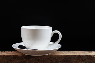 White coffee cup on a black background.