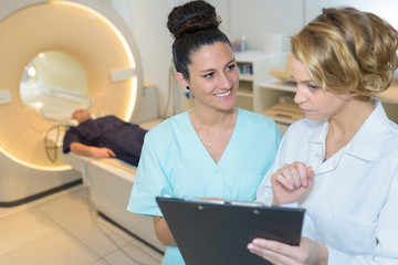 doctors at a cat scan in modern hospital