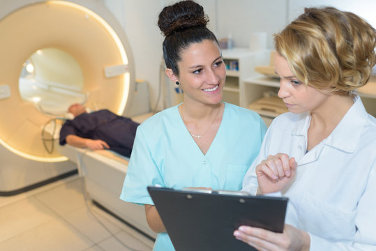 Doctors At A Cat Scan In Modern Hospital