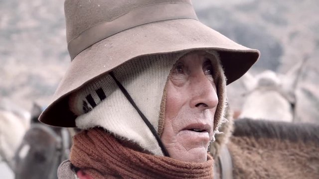 Native quechua man using a chullo and a highlander hat. Peru. Slow motion