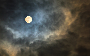 Naklejka na ściany i meble Mysterious midnight cloudy sky with full moon and moonlit clouds