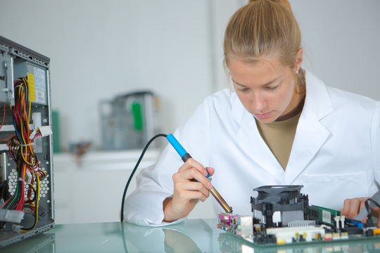 girl with a tester and a printed circuit board