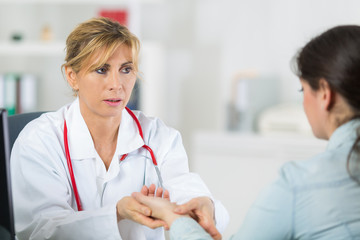 doctor messuring blood pressure of a patient