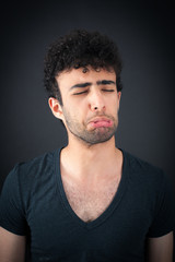 Handsome man doing different expressions in different sets of clothes: sad