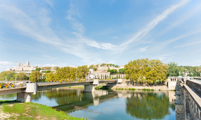 Fototapeta na wymiar Between two bridges at Beziers view across Orb River to city and Cathedral of Saint Nazaire
