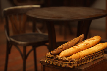 Traditional European boulangerie concept. Basket with baguettes