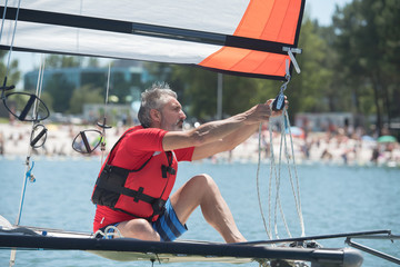 professional waterman training on lake with catamaran