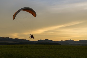 Paraglider flying in the air during colorful sunset. Slovakia