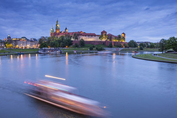 Naklejka na ściany i meble Moving lights on the river before castle in twilight time