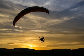 Paraglider flying in the air during colorful sunset. Slovakia