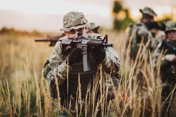 Rangers shooting with his weapon, rifle at sunset. War, army