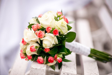 Wedding bouquet of roses on a bench