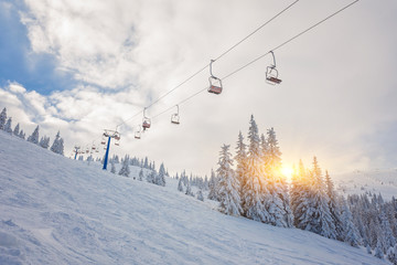 snowboarders on a ski lift