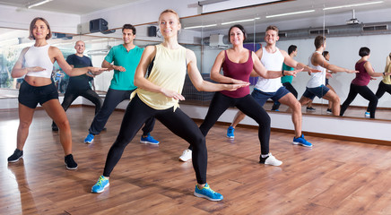 Happy adults having group fitness class