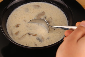 a man taking creamy mushroom soap in black plate