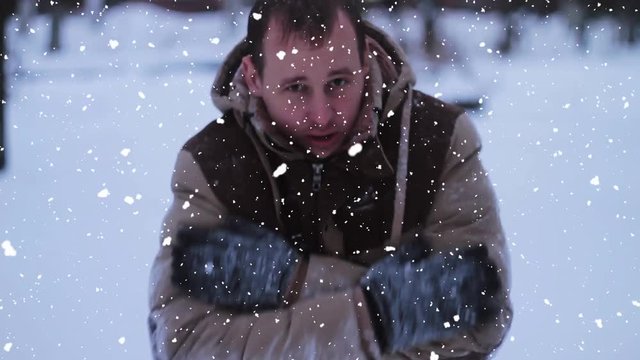 the young man basks in the winter against snow